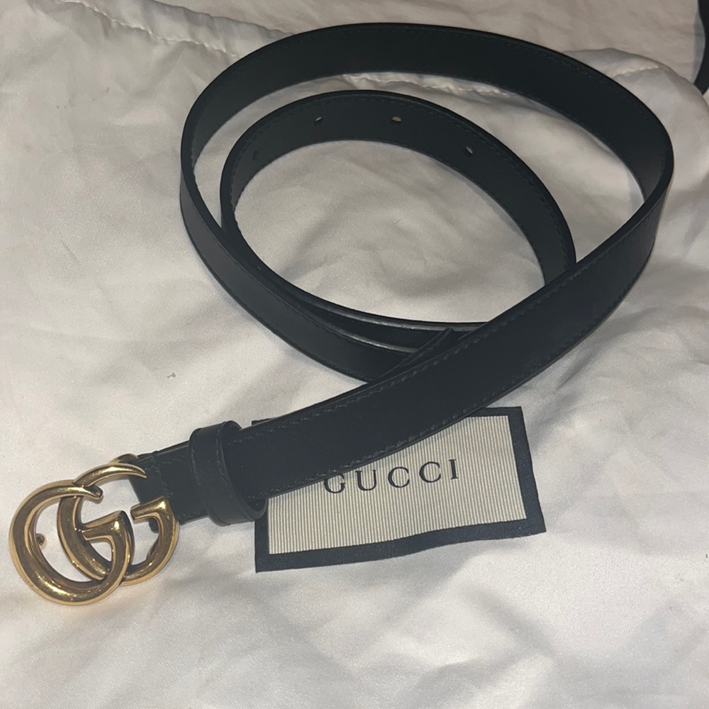 Thin, classic, black Gucci belt with gold hardware